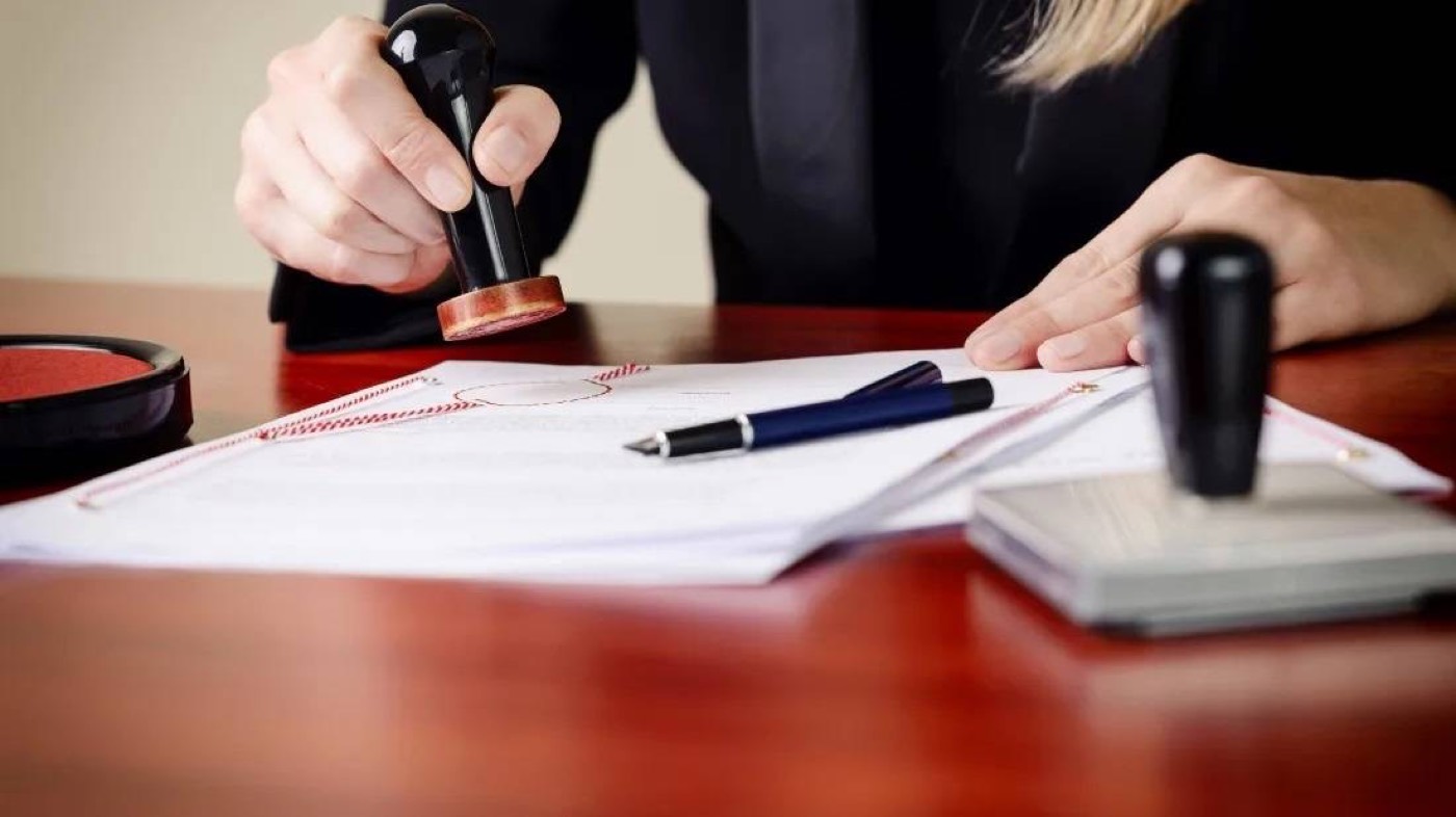 A notary completing a document with a client